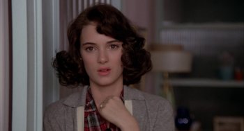 Movie still from “Great Balls of Fire!” (1989), directed by Jim McBride – A young woman with short brown hair wearing a plaid shirt; Close Up shot, Over the shoulder angle