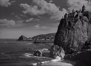 Movie still from “Green Dolphin Street” (1947), directed by Victor Saville – A black and white photo of a rocky beach; Extreme Wide shot, High angle