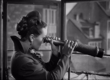 Movie still from “Green Dolphin Street” (1947), directed by Victor Saville – A black and white photo of a woman looking through a telescope; Medium shot, Over the shoulder angle