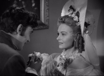 Movie still from “Green Dolphin Street” (1947), directed by Victor Saville – A man and a woman are holding flowers in their hands; Medium shot, Over the shoulder angle