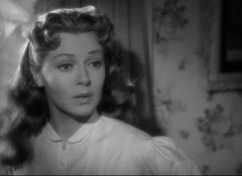 Movie still from “Green Dolphin Street” (1947), directed by Victor Saville – An old black and white photo of a woman in a white shirt; Close Up shot, Over the shoulder angle