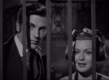 Movie still from “Green Dolphin Street” (1947), directed by Victor Saville – A man and a woman behind bars looking at the camera; Close Up shot, Low angle