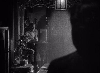 Movie still from “Green Dolphin Street” (1947), directed by Victor Saville – A man sitting on a chair in front of a mirror; Medium shot, Over the shoulder angle
