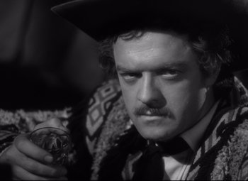 Movie still from “Green Dolphin Street” (1947), directed by Victor Saville – A black and white photo of a man holding a glass; Close Up shot, Over the shoulder angle