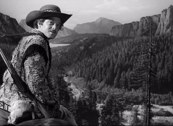 Movie still from “Green Dolphin Street” (1947), directed by Victor Saville – A man wearing a cowboy hat standing on top of a mountain; Medium shot, Low angle