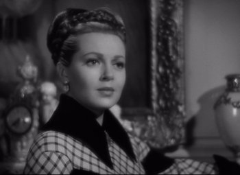 Movie still from “Green Dolphin Street” (1947), directed by Victor Saville – A black - and - white photo of a woman in a plaid shirt; Close Up shot, Over the shoulder angle