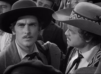 Movie still from “Green Dolphin Street” (1947), directed by Victor Saville – A man in a suit and a man in a cowboy hat; Close Up shot, Over the shoulder angle