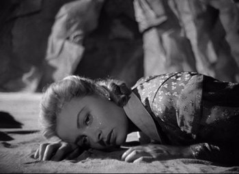 Movie still from “Green Dolphin Street” (1947), directed by Victor Saville – A black and white photo of a woman laying on the ground; Close Up shot, High angle