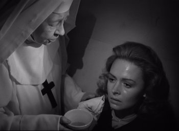Movie still from “Green Dolphin Street” (1947), directed by Victor Saville – An old woman is holding a cup while a nun looks on; Close Up shot, High angle