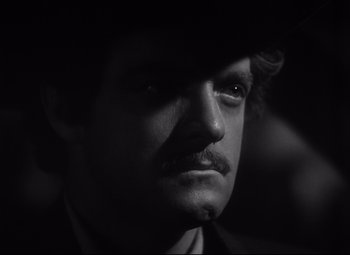 Movie still from “Green Dolphin Street” (1947), directed by Victor Saville – A black and white photo of a man with a mustache; Close Up shot, Over the shoulder angle
