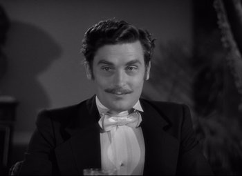 Movie still from “Green Dolphin Street” (1947), directed by Victor Saville – A black and white photo of a man in a tuxedo; Close Up shot, High angle