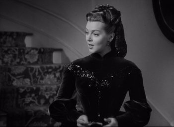 Movie still from “Green Dolphin Street” (1947), directed by Victor Saville – A black and white photo of a woman in a black dress; Medium shot, Over the shoulder angle