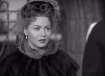 Movie still from “Green Dolphin Street” (1947), directed by Victor Saville – A black and white photo of a woman with a veil; Close Up shot, Over the shoulder angle