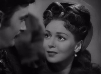 Movie still from “Green Dolphin Street” (1947), directed by Victor Saville – A black and white photo of a woman with curlers in her hair; Close Up shot, Over the shoulder angle