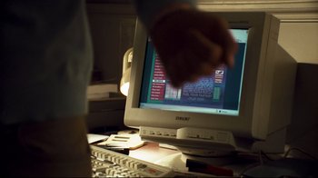 Movie still from “Green Street Hooligans” (2005), directed by Lexi Alexander – A computer monitor sitting on top of a desk; Extreme Close Up shot, High angle