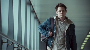 Movie still from “Green Street Hooligans” (2005), directed by Lexi Alexander – A man with a backpack standing in a hallway; Medium shot, Low angle