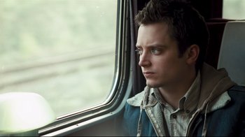 Movie still from “Green Street Hooligans” (2005), directed by Lexi Alexander – A man sitting on a train looking out the window; Close Up shot, Low angle