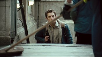 Movie still from “Green Street Hooligans” (2005), directed by Lexi Alexander – A young man standing in front of a mirror holding a rope; Medium shot, Over the shoulder angle