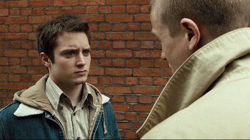 Movie still from “Green Street Hooligans” (2005), directed by Lexi Alexander – Two men standing next to each other in front of a brick wall; Close Up shot, Over the shoulder angle