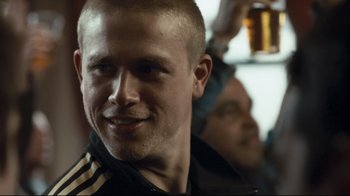 Movie still from “Green Street Hooligans” (2005), directed by Lexi Alexander – A person with a beer; Close Up shot, Over the shoulder angle