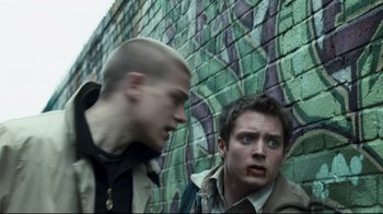 Movie still from “Green Street Hooligans” (2005), directed by Lexi Alexander – Two young men standing next to each other near a brick wall; Medium shot, Low angle