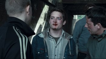 Movie still from “Green Street Hooligans” (2005), directed by Lexi Alexander – A man with blood all over his face; Close Up shot, Over the shoulder angle