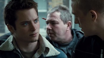 Movie still from “Green Street Hooligans” (2005), directed by Lexi Alexander – A man with a knife stuck in his forehead; Close Up shot, Over the shoulder angle