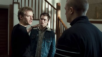 Movie still from “Green Street Hooligans” (2005), directed by Lexi Alexander – A group of young men standing next to each other in front of a mirror; Medium shot, Over the shoulder angle