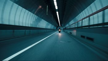 Movie still from “Green Street Hooligans” (2005), directed by Lexi Alexander – A person riding a motorcycle in a tunnel; Extreme Wide shot, High angle
