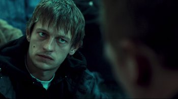 Movie still from “Green Street Hooligans” (2005), directed by Lexi Alexander – A young man looking into a mirror while wearing a black jacket; Close Up shot, Over the shoulder angle