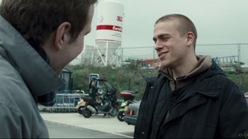 Movie still from “Green Street Hooligans” (2005), directed by Lexi Alexander – Two young men talking to each other on the side of the road; Close Up shot, Over the shoulder angle