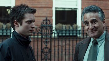 Movie still from “Green Street Hooligans” (2005), directed by Lexi Alexander – Two men standing next to each other in front of a building; Close Up shot, Over the shoulder angle
