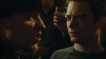 Movie still from “Green Street Hooligans” (2005), directed by Lexi Alexander – Two men are looking at each other while holding drinks; Close Up shot, Over the shoulder angle