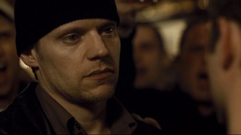Movie still from “Green Street Hooligans” (2005), directed by Lexi Alexander – A person wearing a hat; Close Up shot, Over the shoulder angle