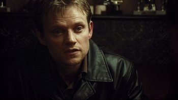 Movie still from “Green Street Hooligans” (2005), directed by Lexi Alexander – A person wearing a leather jacket; Close Up shot, Over the shoulder angle