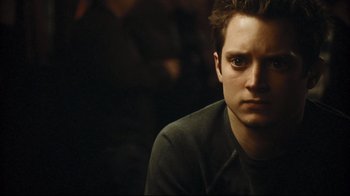 Movie still from “Green Street Hooligans” (2005), directed by Lexi Alexander – A person sitting down looking at the camera; Close Up shot, Low angle