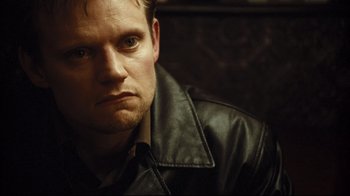 Movie still from “Green Street Hooligans” (2005), directed by Lexi Alexander – A person wearing a leather jacket; Close Up shot, High angle