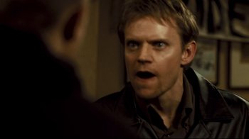 Movie still from “Green Street Hooligans” (2005), directed by Lexi Alexander – A person looking at the camera; Close Up shot, Over the shoulder angle