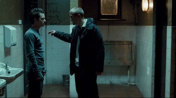 Movie still from “Green Street Hooligans” (2005), directed by Lexi Alexander – Two men are standing in a bathroom talking; Medium shot, Low angle