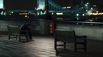 Movie still from “Green Street Hooligans” (2005), directed by Lexi Alexander – A man sitting on a bench in the dark; Wide shot, High angle