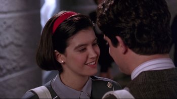 Movie still from “Gremlins 2: The New Batch” (1990), directed by Joe Dante – A young woman smiling at a young man; Close Up shot, Over the shoulder angle