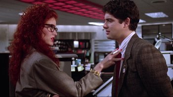 Movie still from “Gremlins 2: The New Batch” (1990), directed by Joe Dante – A man and a woman are talking in a restaurant; Medium shot, Over the shoulder angle