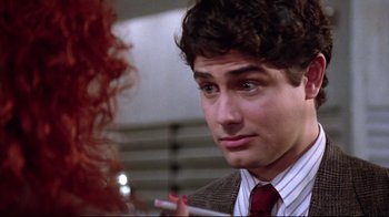 Movie still from “Gremlins 2: The New Batch” (1990), directed by Joe Dante – A man smoking a cigarette in a room; Close Up shot, Over the shoulder angle