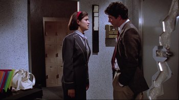 Movie still from “Gremlins 2: The New Batch” (1990), directed by Joe Dante – A man and a woman standing next to each other in front of lockers; Medium shot, Over the shoulder angle