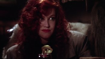 Movie still from “Gremlins 2: The New Batch” (1990), directed by Joe Dante – A person holding an apple; Close Up shot, Low angle