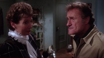 Movie still from “Gremlins 2: The New Batch” (1990), directed by Joe Dante – A man and a woman talking to each other; Close Up shot, Over the shoulder angle