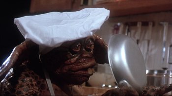 Movie still from “Gremlins 2: The New Batch” (1990), directed by Joe Dante – A person wearing a chef's hat; Close Up shot, Low angle