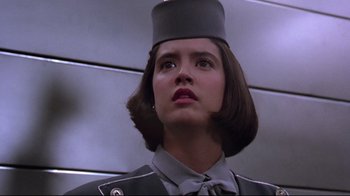 Movie still from “Gremlins 2: The New Batch” (1990), directed by Joe Dante – A woman in a uniform with a hat on her head; Close Up shot, Low angle