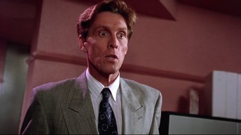 Movie still from “Gremlins 2: The New Batch” (1990), directed by Joe Dante – A person wearing a suit and tie; Close Up shot, Low angle