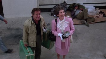 Movie still from “Gremlins 2: The New Batch” (1990), directed by Joe Dante – A man and a woman walking down a street; Wide shot, High angle